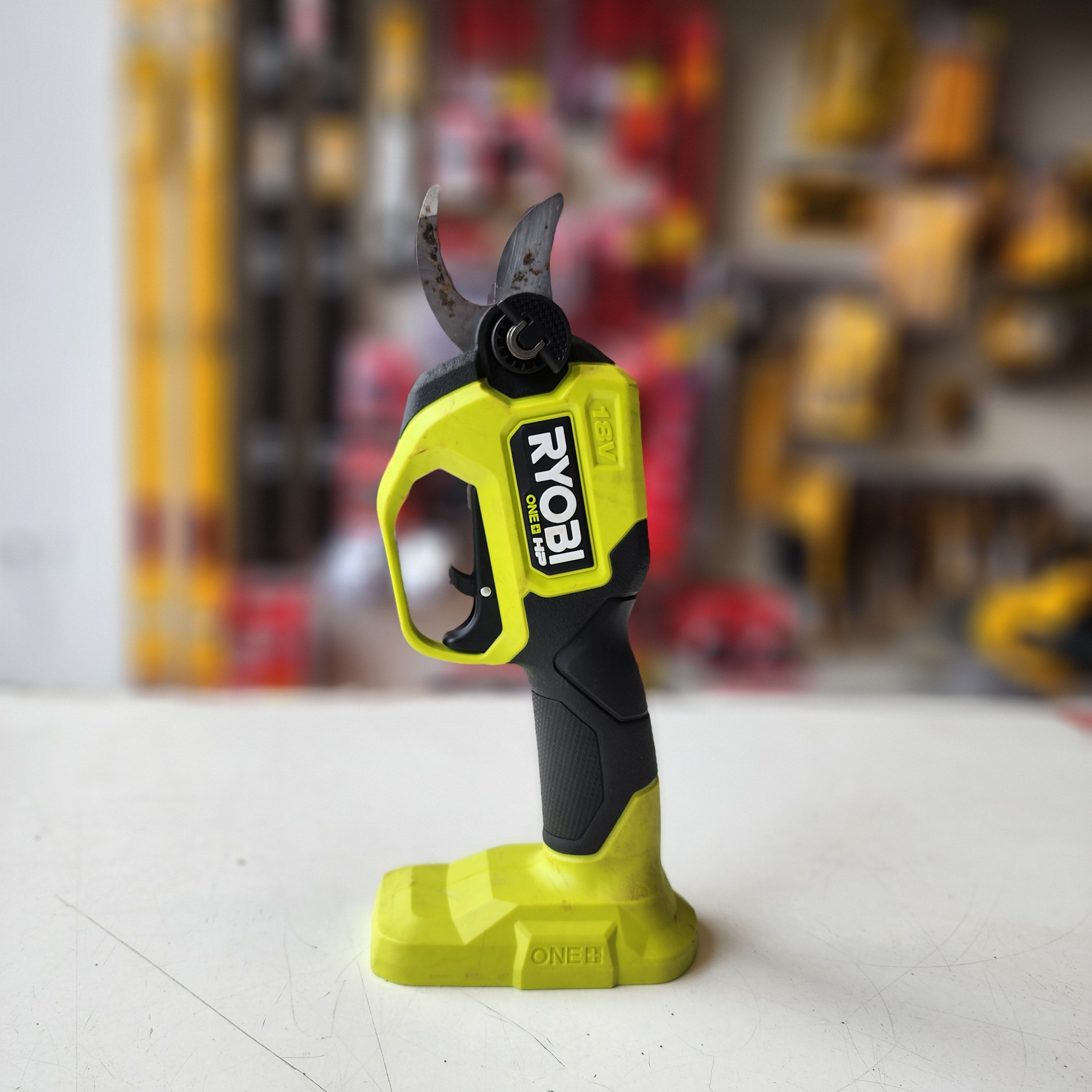 handheld Ryobi pruner for yard and garden maintenance