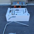 Sierra de mesa portátil con cable Pro Jobsite RIDGID R4514 de 15 amperios y 10 pulgadas con soporte, caja abierta